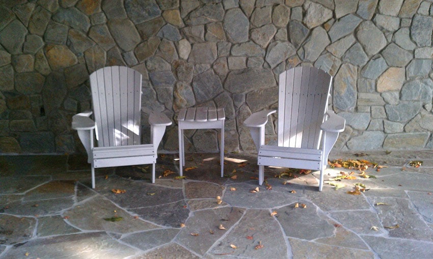 Chairs and Table Behind Stone Wall